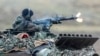 A soldier fires a machine gun from a Leopard 2 tank at a training ground in Augustdorf, Germany, in 2023. "If America doesn't come back on board" to support Ukraine, security expert Michael Clarke says, "then it really matters what Germany does."