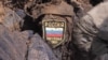 A dead soldier in Luhansk, Ukraine, bears the sigil of the Russian military on his uniform. 