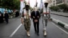 Iranian Basij paramilitary force members, dressed in the style of Palestinian and Lebanese militants, pretend to have detained Israeli Prime Minister Benjamin Netanyahu during a state-sponsored, pro-Palestinian rally after Friday Prayers in Tehran on October 13.