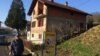 Marko Pranjic from the village of Makljenovac stands outside his home, which straddles the both the dividing line between two of Bosnia-Herzegovina's ethnically based entities. 