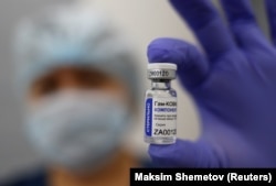 A medical worker shows a vial with Sputnik-V (Gam-COVID-Vac) vaccine on December 3.