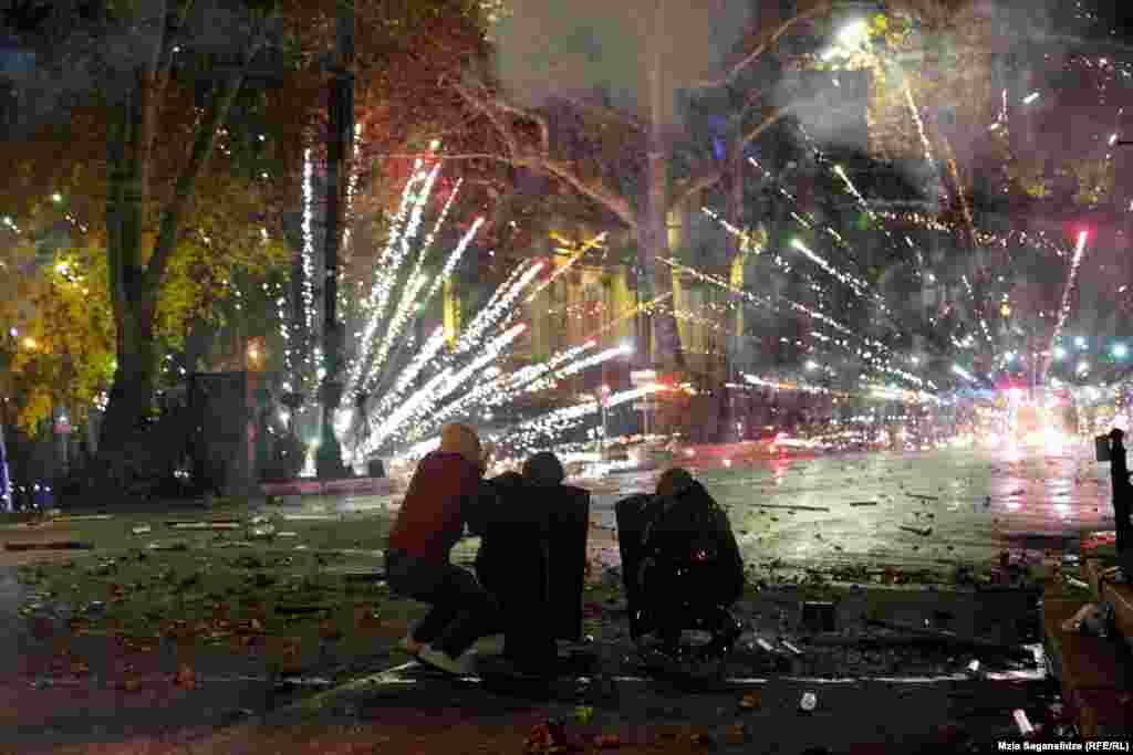 Protestors shoot fireworks toward police on December 4 amid protests along Tbilisi&rsquo;s Rustaveli Avenue. The current unrest over the Georgian government&rsquo;s decision to halt EU accession talks has centered around this thoroughfare in Tbilisi. It is the latest in a long list of political upheavals the street has endured. &nbsp;