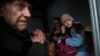 A family sits inside a van as they wait to be evacuated from the frontline Ukrainian town of Pokrovsk late last month. 