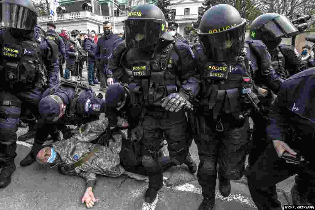 Police detain a counterprotester outside the Russian Embassy in Prague during an anti-Russia protest on April 18.