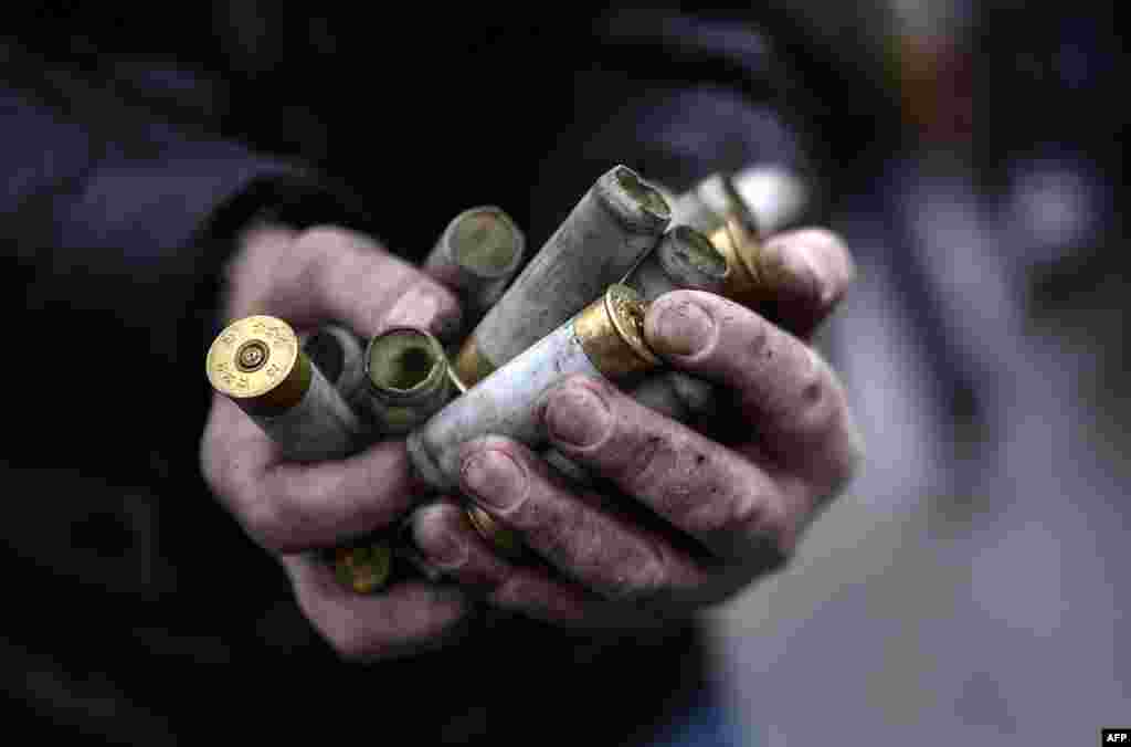 Protester shows empty bullet casings used by riot police against demonstrators.