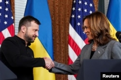 Democratic presidential nominee and U.S. Vice President Kamala Harris shakes hands with Zelenskiy as they meet in Washington, D.C., on September 26.