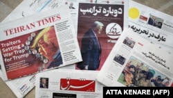 Iranian daily newspapers at a newsstand in Tehran on January 21 include Sazandegi (center), which leads with a piece on U.S. President Donald Trump titled "Trump Again."