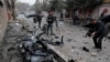 Afghan journalists film at the site of a bombing attack in Kabul on February 20.