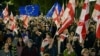 Protesters wave flags during a pro-Europe rally in Tbilisi on October 20, ahead of the parliamentary elections.