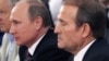 Ukrainian politician Viktor Medvedchuk (right) and Russian President Vladimir Putin in Kyiv on July 27