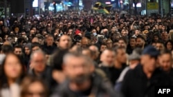 People take part in an opposition march in Belgrade on December 25. 