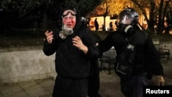 A Georgian police officers detains a demonstrator during an opposition rally in Tbilisi on November 30. 