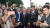 In a photo from the president's website, President Shavkat Mirziyoyev (center) poses with bloggers and journalists in Samarkand in August 2019.
