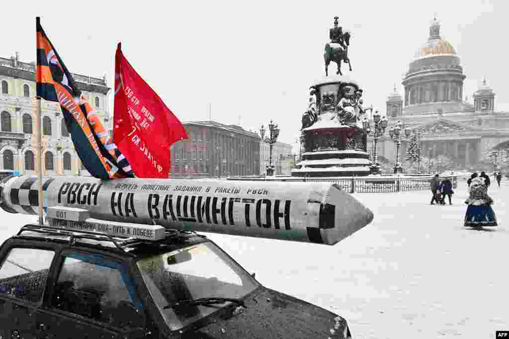 A mockup of a missile with the inscription reading as &#39;Toward Washington. Threatening U.S. territory is the path to victory&quot; is seen on the roof of a car parked in front of St. Isaac&#39;s Cathedral in St. Petersburg on January 12.