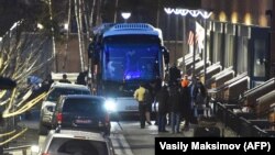 U.S. diplomats and their families who were expelled from Russia prepare to board a bus to leave the embassy compound in Moscow on April 5.