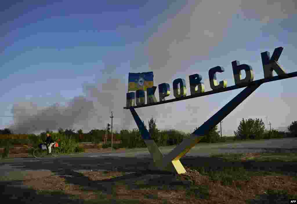 A man rides past the entrance sign on the outskirts of Pokrovsk in September 2024. Since July, Russian forces have been pushing directly toward Pokrovsk, which was once home to some 60,000 people and is seen as a gateway to the Donetsk region. &nbsp;