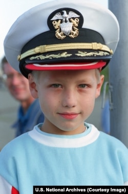 A Russian boy wears a U.S. naval officer's cap in Vladivostok.