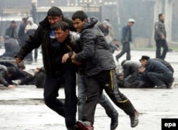 Participants in a Kyrgyz opposition rally run for their lives during unrest in Bishkek on April 7, 2010.