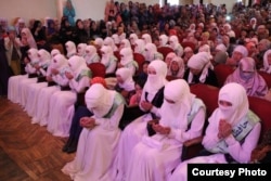 Kyrgyz women wear niqab-style clothing at an official event in the southern city of Osh in 2016.