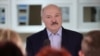 Alyaksandr Lukashenka talks to medical workers during a visit to a district hospital in Stolbtsy on December 8. Even before the election in August, his handling of the coronavirus pandemic angered many in Belarus.