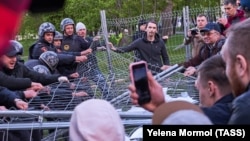 Riot police and protesters facing off in Yekaterinburg on May 14 over plans to build a church in a central park. 