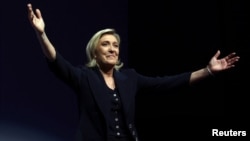 National Rally leader Marine Le Pen reacts on stage in Henin-Beaumont, France, after hearing partial results in the first round of the French parliamentary elections.