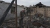 A man stands in the ruins of his farm, which was destroyed by shelling near the village of Taghavard in Nagorno-Karabakh.