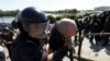 Policemen detain a man who attacked a gay pride march in Kyiv on June 6. 