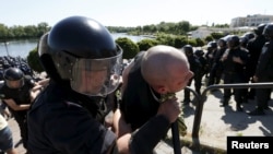 Policemen detain a man who attacked a gay pride march in Kyiv on June 6. 