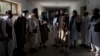 Taliban fighters chat with former prisoners after their release at the Pul-e Charkhi Prison in Kabul on September 13.