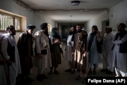 Taliban fighters, some of them former prisoners, chat in an empty area of the Pul-e Charkhi Prison in Kabul on September 13.