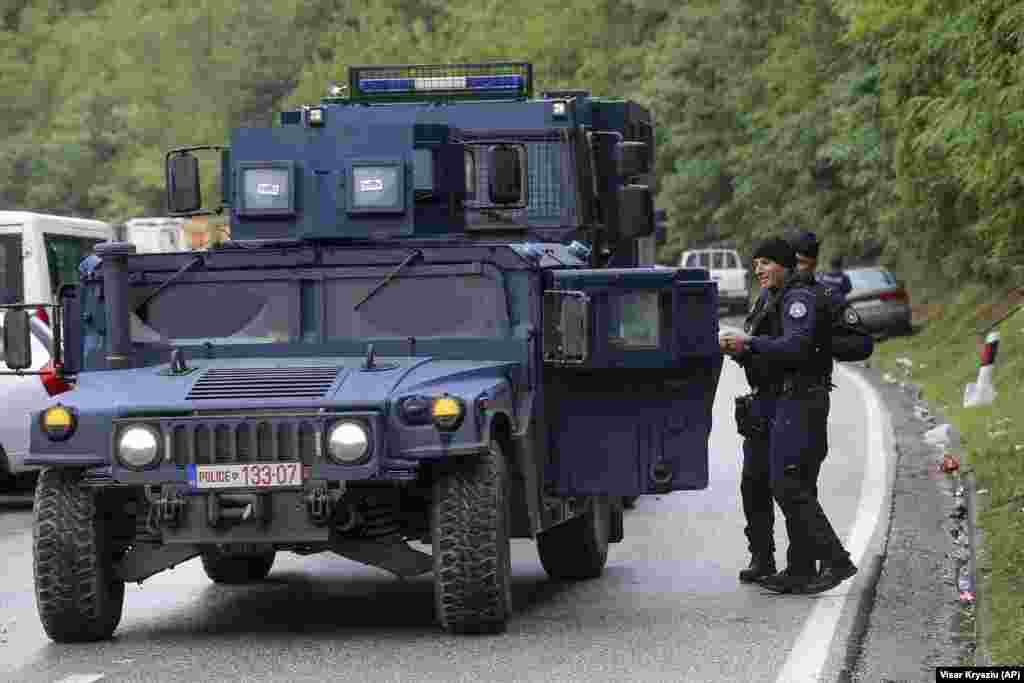 Kosovar police secure the area as ethnic Serbs gathered on barricades near Jarinje on September 28. Vucic has described Kosovo&#39;s recent license-plate move as a &quot;criminal action,&quot; and he made the withdrawal of all Kosovar special police a condition of EU-mediated negotiations to resolve the dispute.