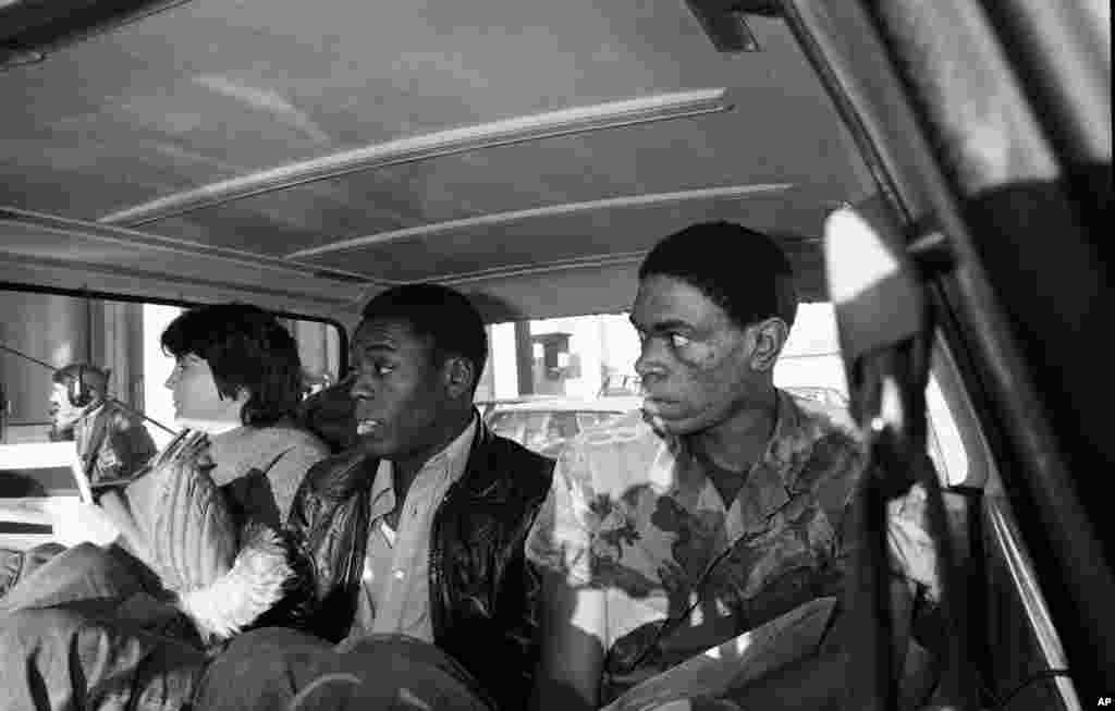 Three hostages released from the U.S. Embassy on November 19, 1979, are driven from a press conference to the airport. From left: Kathy Gross, 22, of Cambridge Spring, Pennsylvania; Marine Sergeant Ladell Maples, 23, of Earle, Arkansas; and Marine Sergeant William Quarles, 23, of Washington, D.C.