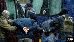 Security agents detain two demonstrators during a protest in Minsk in November 2020.