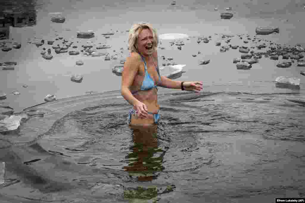 A Ukrainian swimmer takes a traditional dip in icy water during celebrations of Epiphany in Kyiv on January 6.