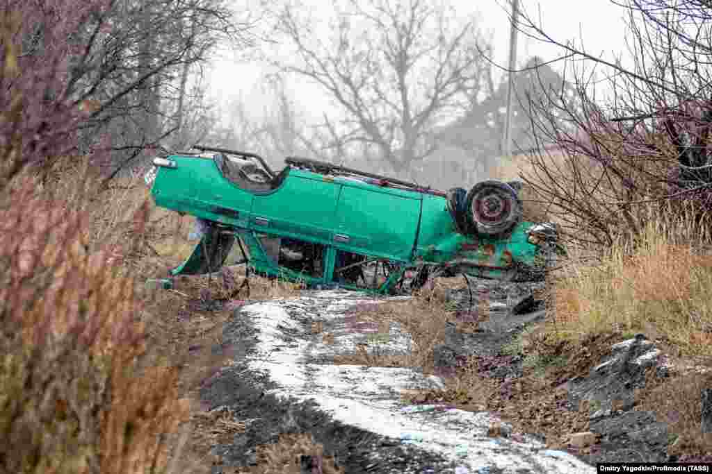 An upturned car on what was once a street in Maryinka, photographed on December 4.&nbsp;