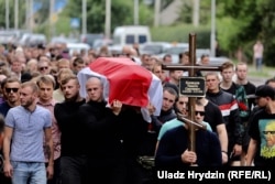 People attend the funeral of Mikita Kryutsou in Maladzyechna on August 25. Kryutsou disappeared after a protest on August 12. His body was found 10 days later. There are many questions still surrounding the nature of his death, although officials suggested it was suicide.