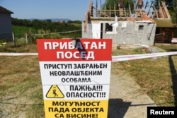 A sign saying "Access forbidden to unauthorized persons" in front of a house bought by Rio Tinto in Gornje Nedeljice to make way for the mine.