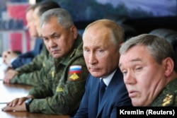 Russian President Vladimir Putin (center) is accompanied by Defense Minister Sergei Shoigu (left) and General Valery Gerasimov, the chief of staff of the Russian Armed Forces, during military exercises in September 2020.