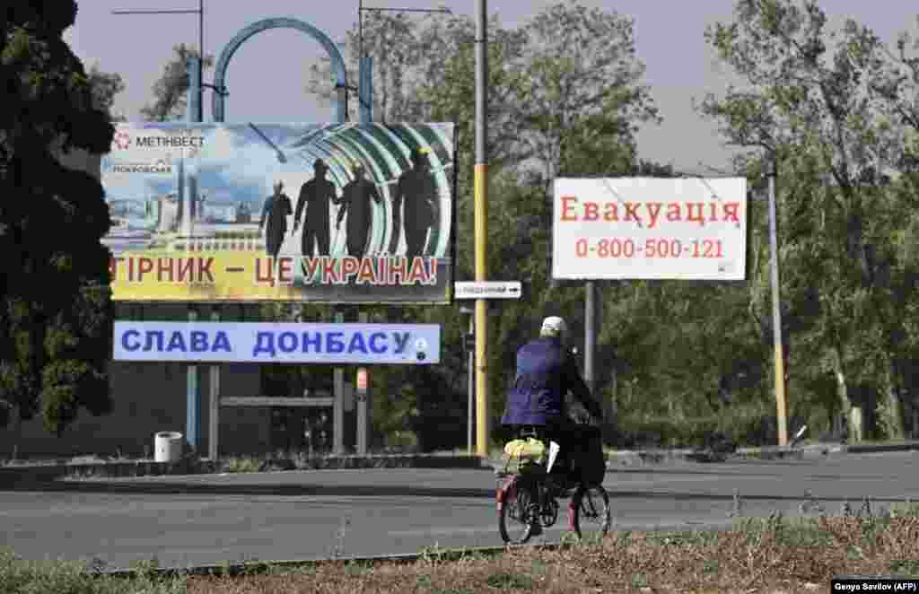 Signs in Pokrovsk including one (right) displaying a phone number for people who want to be evacuated. Around 13,000 residents were believed to remain in the city as of October 4. &nbsp;