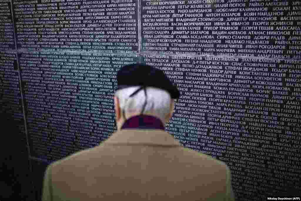 A man in Sofia searches for the names of relatives on a monument dedicated to victims of the communist regime in Bulgaria.