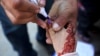 A health worker marks the finger of a child who just received the polio vaccine in Lahore on February 18, shortly before the nation shifted gears to fight the coronavirus pandemic.