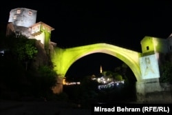 The iconic bridge in Mostar, Bosnia-Herzegovina, is illuminated for an event called Golden September, held to raise awareness about childhood cancer, on September 1. (Mirsad Behram, RFE/RL)