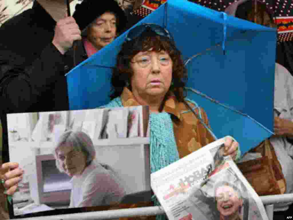 A woman holds pictures of Politkovskaya in Moscow in 2008.