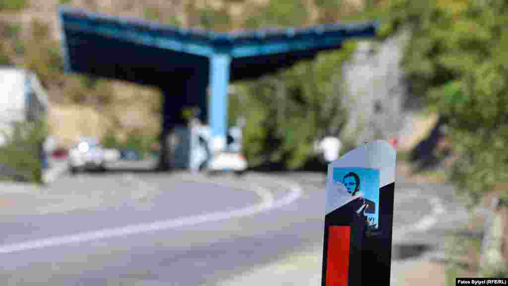 A picture of Serbian President Aleksandar Vucic is seen close to a border crossing at Jarinje. The confrontation has already boiled over into violence, with a vehicle-registration office and another Interior Ministry building in northern Kosovo being attacked on September 25, according to police.