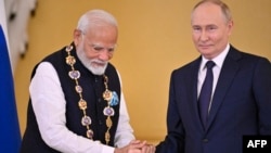 Russian President Vladimir Putin decorates Indian Prime Minister Narendra Modi with the Order of St. Andrew the Apostle the First-Called during a ceremony following their talks at the Kremlin in Moscow on July 9. 