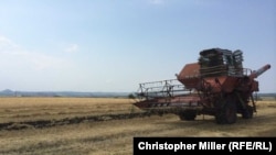 The combine harvester of Vasily, a local farmer who works the fields where the launch site was located