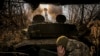 A Ukrainian soldier fires a howitzer toward Russian positions near Chasiv Yar in eastern Ukraine. 