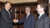 Russia's Dmitry Medvedev (right) looks on as Armenia's Serzh Sarkisian (center) and Azerbaijan's Ilham Aliyev shake hands in Moscow.