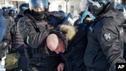 Police detain a man during a protest against the jailing of opposition leader Aleksei Navalny in Khabarovsk on January 23.